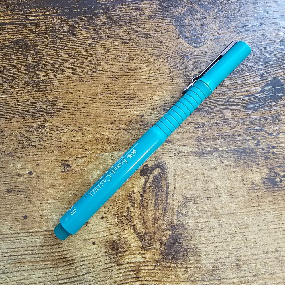 Faber-Castell Ecco Pigment fineliner blue pen with a turquoise barrel